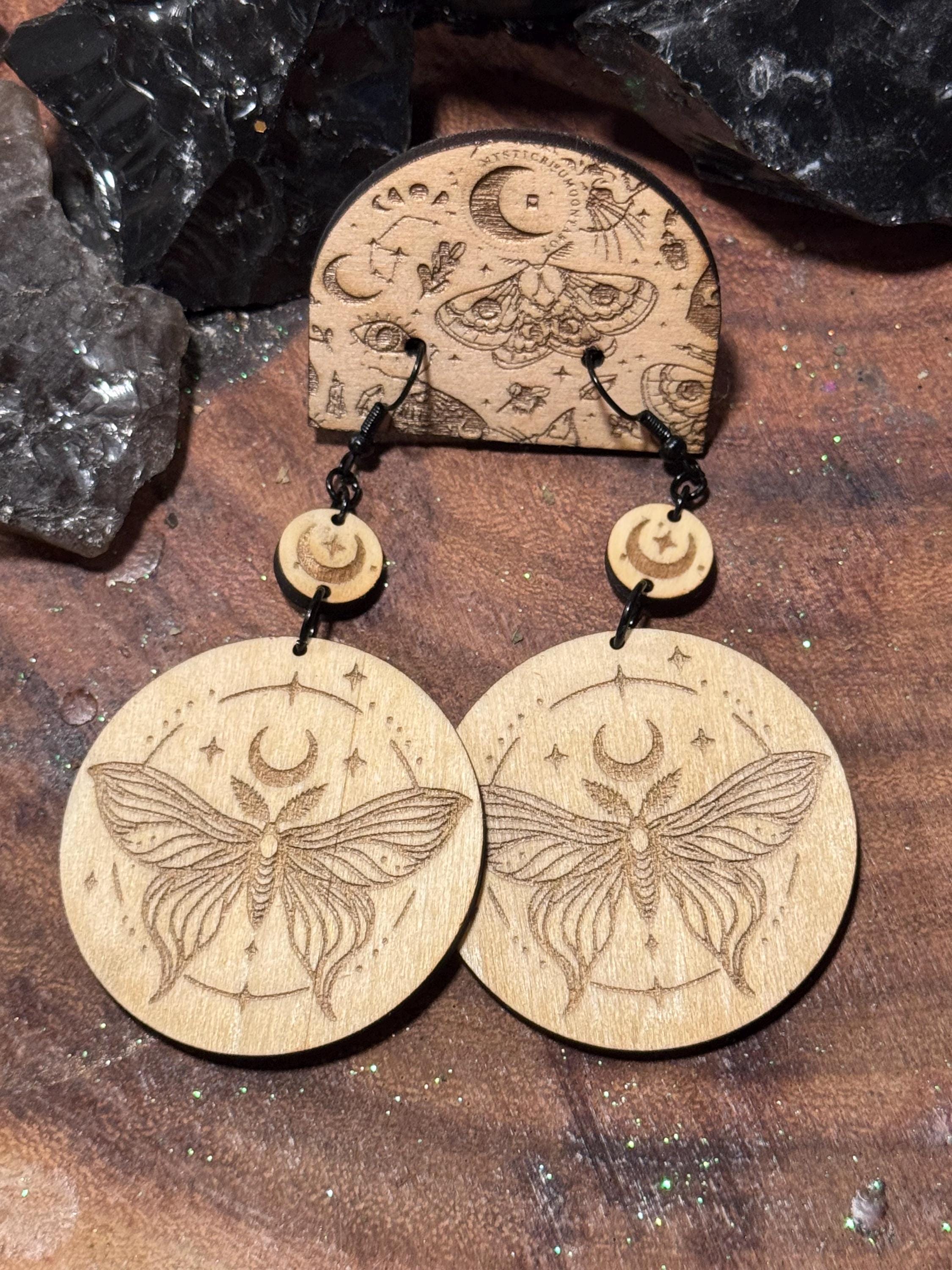 Handmade laser-engraved wooden earrings featuring a moth and crescent moon design, perfect for witchy, boho, and celestial jewelry lovers.