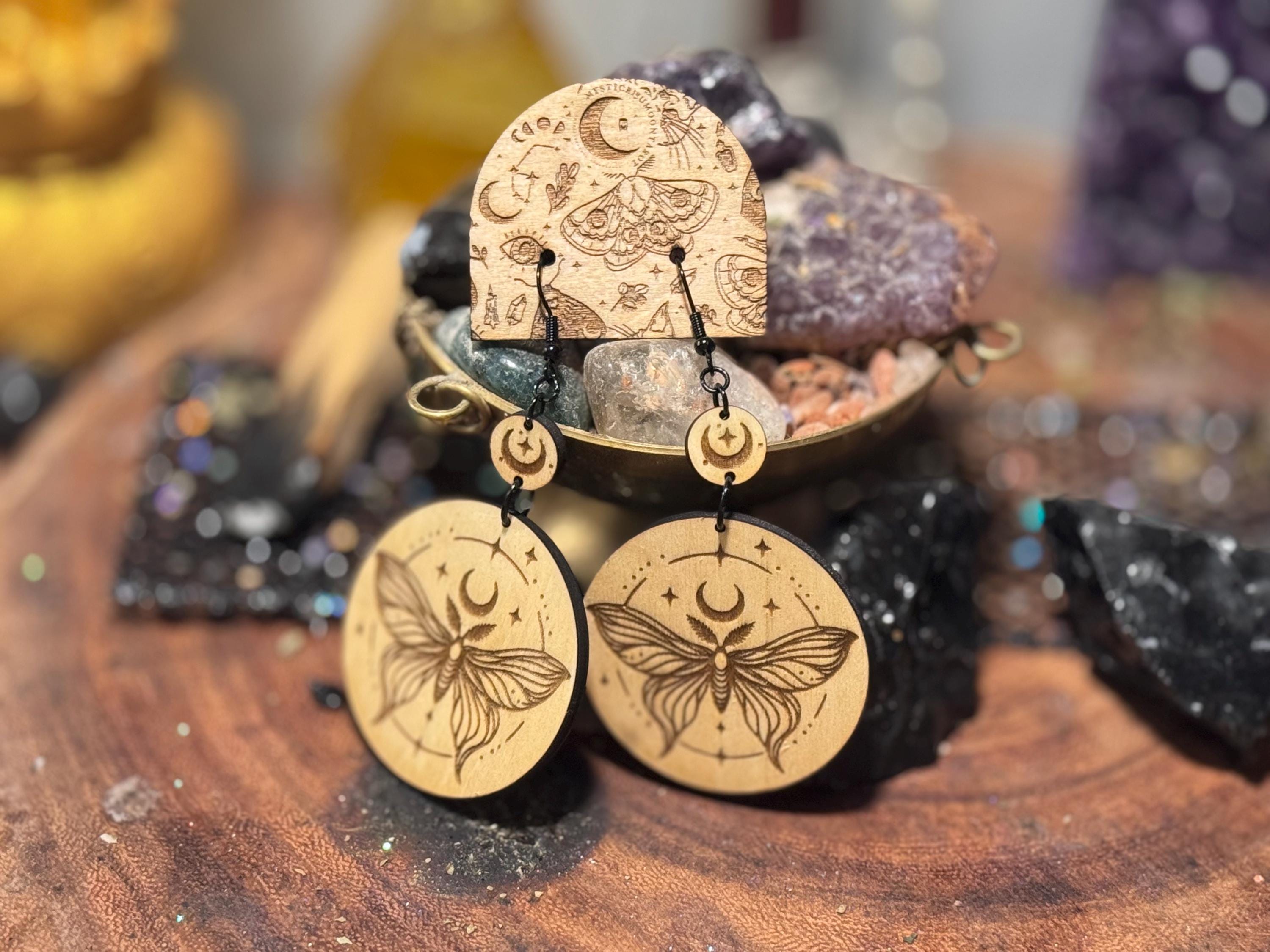 Handmade laser-engraved wooden earrings featuring a moth and crescent moon design, perfect for witchy, boho, and celestial jewelry lovers.