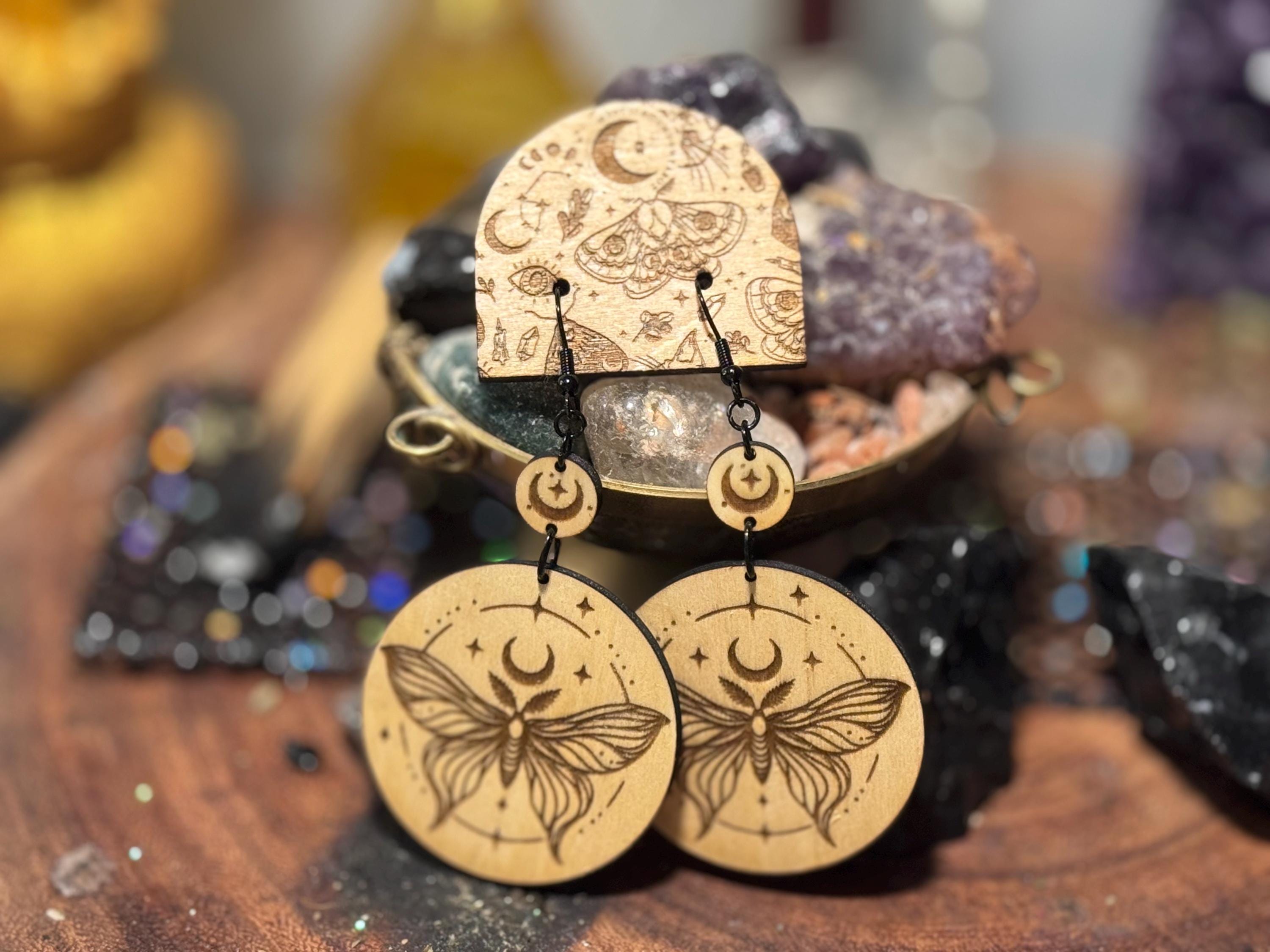 Handmade laser-engraved wooden earrings featuring a moth and crescent moon design, perfect for witchy, boho, and celestial jewelry lovers.