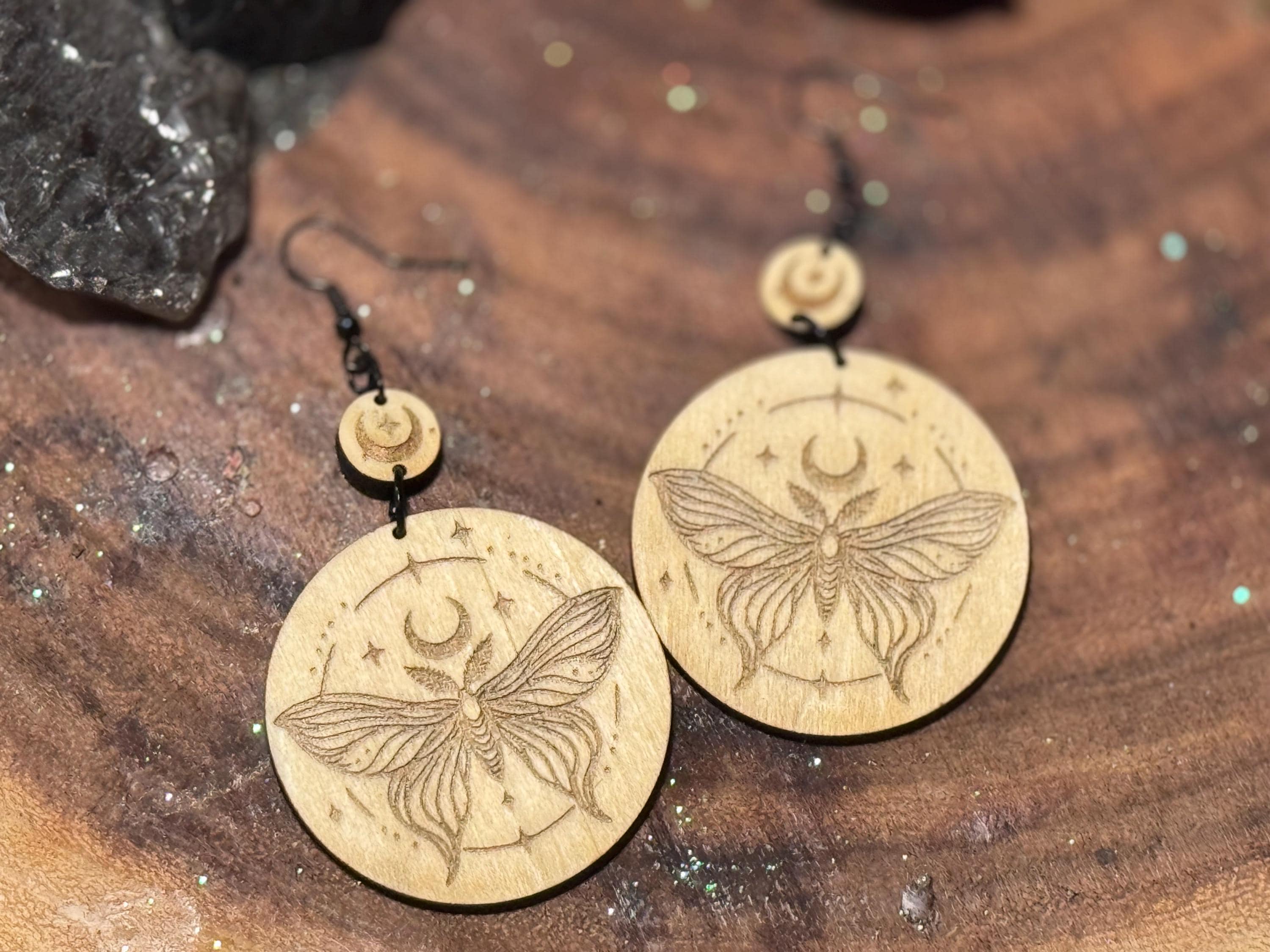 Handmade laser-engraved wooden earrings featuring a moth and crescent moon design, perfect for witchy, boho, and celestial jewelry lovers.