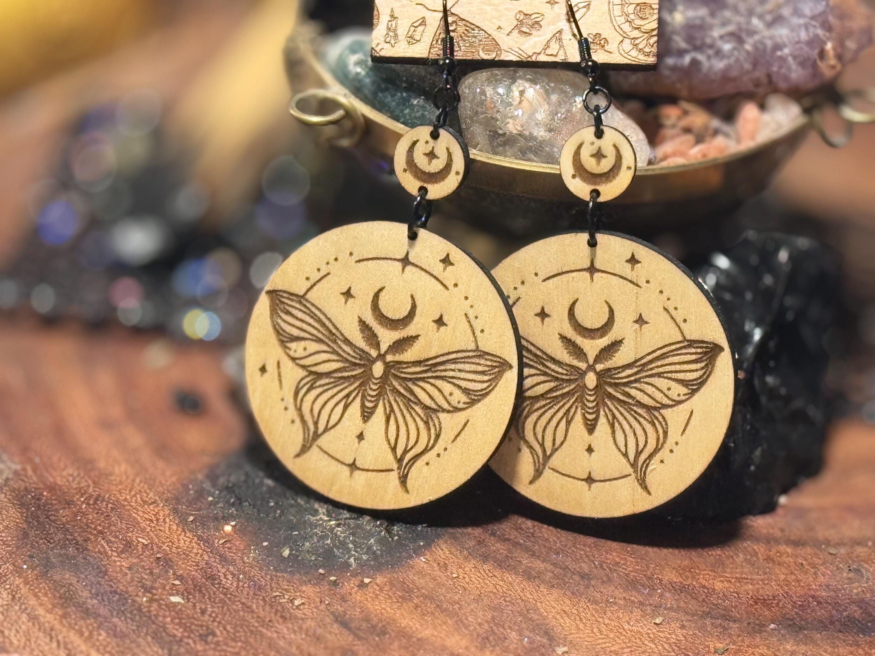 Handmade laser-engraved wooden earrings featuring a moth and crescent moon design, perfect for witchy, boho, and celestial jewelry lovers.